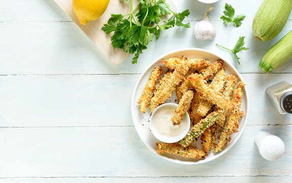Baked crispy zucchini fries served with dipping sauce