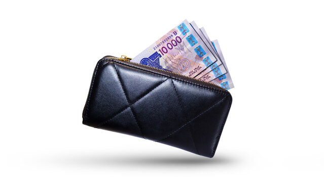 West African  CFA Franc  money currency notes inside a black purse isolated on a white background