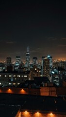 Naklejka premium Nighttime cityscape from a rooftop.