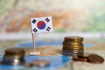 south korea flag on map with coins, concept of finance, national economy, savings, investment,...