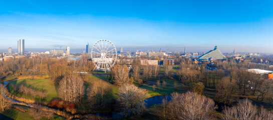 Aerial view of Riga, Latvia, featuring the Ferris wheel in Victory Park, the National Library's...