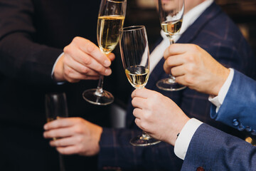 Group of businessmen celebrate, closing successful concluded deal, guests clinking raise glasses...