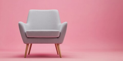 Fototapeta premium Modern gray armchair on pink background.