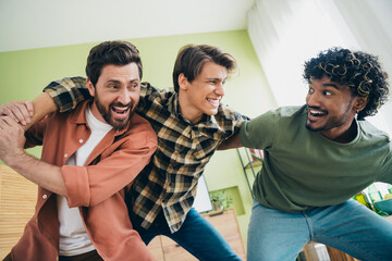Portrait of three best friends carefree fight gather chill free time modern interior flat indoors