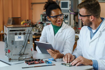 Diverse Scientists with Tablet Controlling Robotics