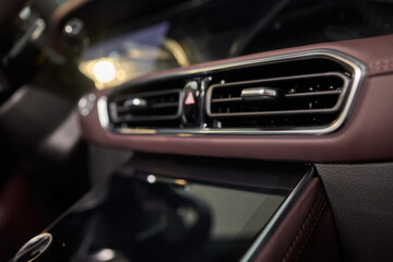 Naklejka premium Closeup of car dashboard air vents near gear shift