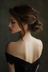 A woman in a black dress with her hair up