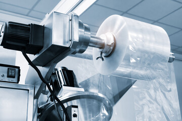 Automatic polyethylene plastic bag production machine with lighting effect. Close-up of the roller...