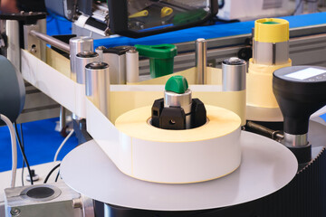 Fragment of the conveyor of sticking labeling machine. Abstract industrial background.