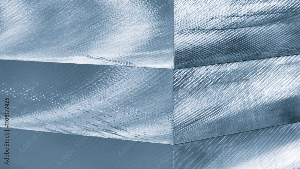Fototapete A blue piece of metal with a pattern on it. The pattern is made up of lines. The lines are very thin and are in different directions