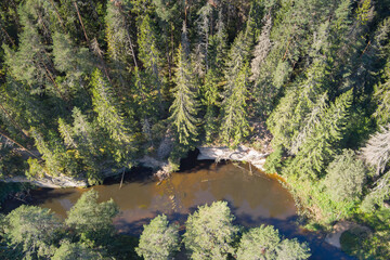 Estonian nature, Vaike Taevaskoja sandstone and cave in summer morning, photo view from drone....