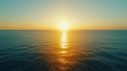 Obraz premium Sunset over calm ocean waters with golden reflections and vibrant sky colors