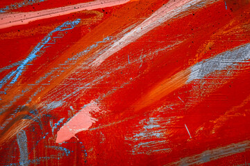 Messy paint strokes and smudges on an old grunge wall background. Red, orange, white, blue color...