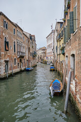 Fototapeta premium Venice: landscape with the image of boats on a channel in Venice, Italy