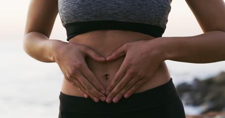 Woman, hands and fitness with stomach for gut health, balance or belly wellness in nature. Closeup,...