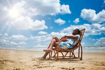 Young black man or African relaxing at the beach on a bright sunny day with blue skies.