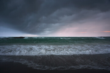 Rain clouds over the sea at sunset. The Isle of North Uist, Scotland