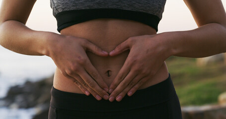 Woman, hands and balance with stomach for gut health, fitness or belly wellness in nature. Closeup,...