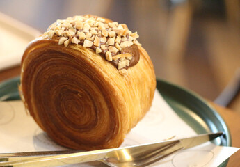 timbering nutella croissant with nuts on plate.
