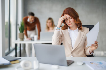Businesswoman Struggling With Stress In Modern Office Environment