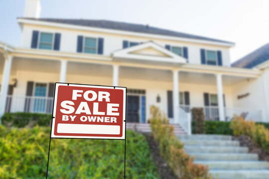 For Sale By Owner Real Estate Yard Sign In Front of House.