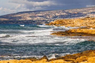 Fototapeta premium rocky coastline with crashing waves on the island of Cyprus near the city of Paphos in Greece in November