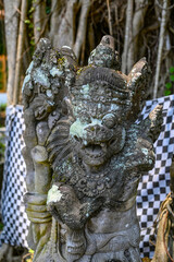 Balinese statue in the middle of a garden, Bali, Indonesia