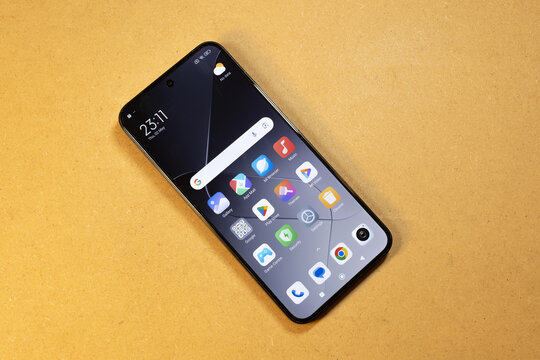 Modern Xiaomi Android smartphone lying on the table, top view of default apps mobile device home screen interface app icons simple concept, pre-installed software display