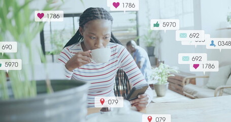 Image of media icons over biracial woman using smartphone