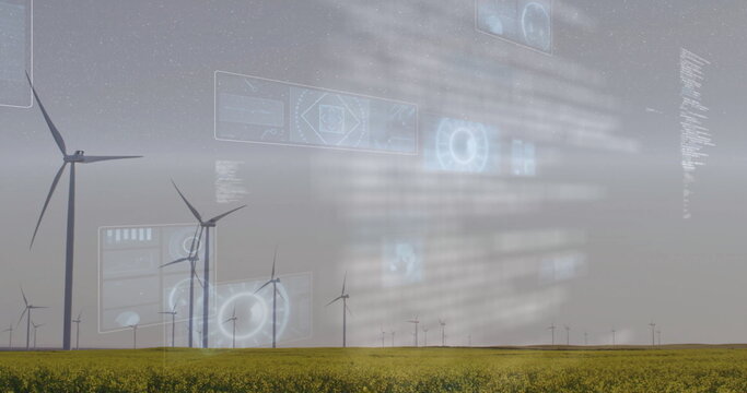 Wind turbines in field with futuristic data processing image over landscape