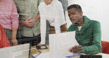 Analyzing data and discussing, diverse team in office with digital interface image