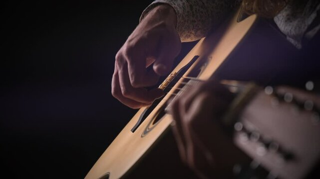 Beginner guitar playing.
The musician plays the rhythm on a wooden acoustic guitar, pressing the strings with his fingers.
08.11.2024