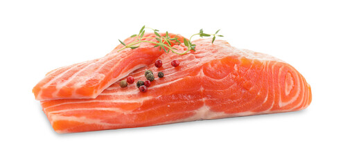 Pieces of fresh salmon, peppercorns and thyme isolated on white