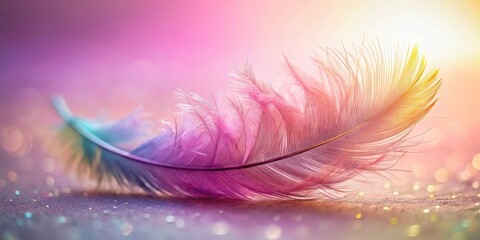 Obraz premium A Single Feather Glistens with Delicate Hues of Pink and Yellow Against a Softly Blurred Background of Light and Sparkle