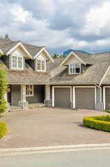 Garage door in luxury house with trees and nice landscape in Summer in Vancouver, Canada, North...