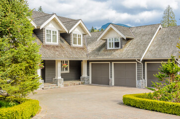 Garage door in luxury house with trees and nice landscape in Summer in Vancouver, Canada, North...