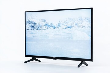 Fototapeta premium Flat-screen television displaying snowy mountain landscape