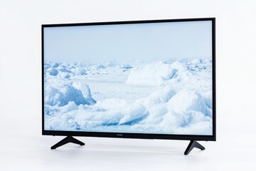 Fototapeta premium Flat screen tv displaying arctic ice landscape with clear blue sky