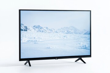 Fototapeta premium Flat screen tv displaying snowy mountain landscape on black stand