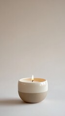 Elegant ceramic candle with a gentle flame, perfect for creating a calming atmosphere in modern interiors.