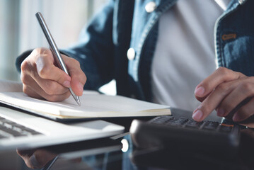 Close up business woman using calculator tocalculate home finance and working on laptop computer, calculate expenses, business finance and investment, budget management