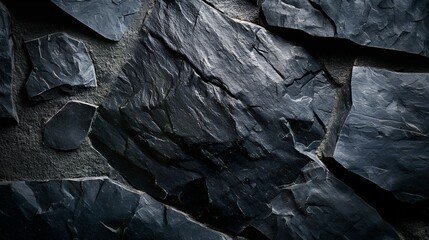 High-resolution photography of rustic black stone surfaces with natural imperfections.
