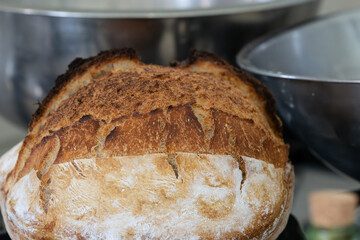 Sough-dough bread mixing and baking. with loaf just out of oven