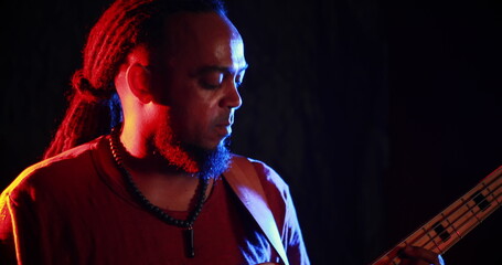 Fototapeta premium Guitarist playing electric guitar at nightclub