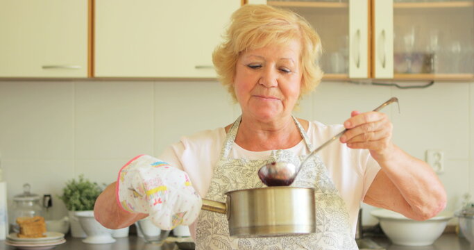 Senior woman preparing jam in kitchen