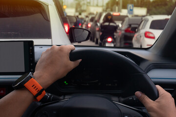 Fototapeta premium People driving inside car and many cars on the road jam in traffic junction by red light control, Rush hour in Thailand on day.