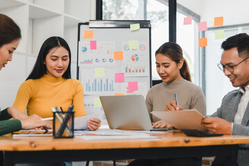 Collaborative team meeting with diverse professionals discussing data analysis and strategies. Engaged individuals share ideas and insights in modern workspace