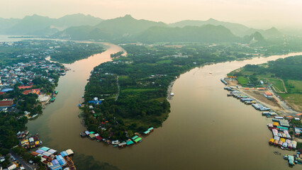 Fototapeta premium aerial sunset view of Kanchanaburi on the River Kwai drone above Thailand travel destination