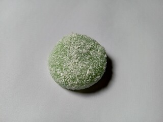 matcha flavored mochi cake on white background.