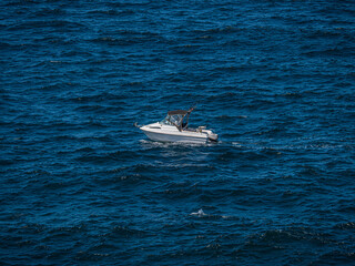 Fototapeta premium Small Cabin Cruiser Trolling In Large Seas